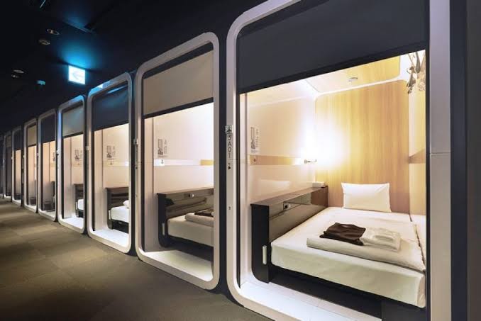 Sleeping pods along a corridor at First Cabin Kansai Airport